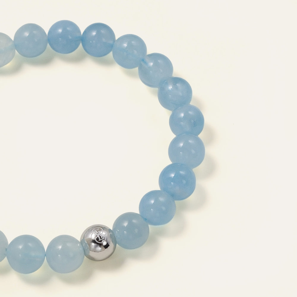 Core Essential bracelet featuring 8mm AAA natural Brazilian Aquamarine with oceanic blue translucency and the Soul Lykke white gold PVD signature bead. This is a natural gemstone and healing crystal bracelet by Soul Lykke.