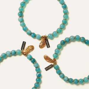 A grouping of three handcrafted icy amazonite bracelets showcasing authentic perthitic textures and a pearlescent schiller effect, highlighting the unique natural variations of high-vibrational Mozambique crystals.