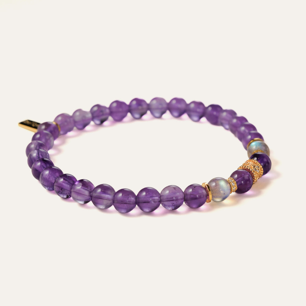Top-down view of the Soul Lykke Quiet Anchor bracelet on a neutral background, featuring 6mm AA+ Brazil Amethyst, twin AAA Labradorite stones, 24k gold-plated CZ accents, and a signature 14K gold PVD surgical steel tag. This is a natural gemstone and healing crystal bracelet by Soul Lykke.
