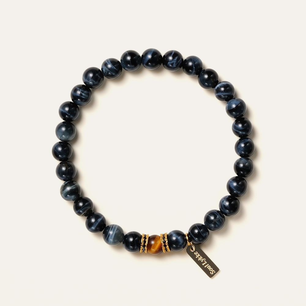 8mm natural Blue Tiger's Eye beaded bracelet featuring a golden Tiger's Eye center stone and a gold Soul Lykke tag. This is a natural gemstone and healing crystal bracelet by Soul Lykke.