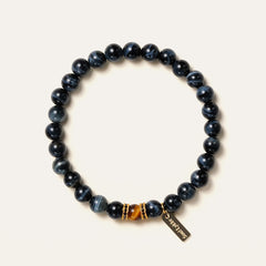 8mm natural Blue Tiger's Eye beaded bracelet featuring a golden Tiger's Eye center stone and a gold Soul Lykke tag. This is a natural gemstone and healing crystal bracelet by Soul Lykke.