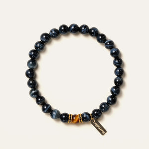 8mm natural Blue Tiger's Eye beaded bracelet featuring a golden Tiger's Eye center stone and a gold Soul Lykke tag. This is a natural gemstone and healing crystal bracelet by Soul Lykke.