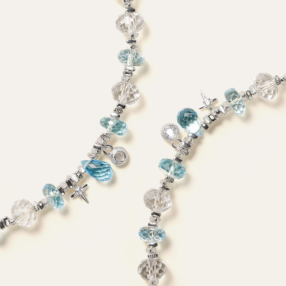 Faceted natural Clear Quartz and Blue Topaz beaded bracelet with an adjustable chain and the engraved Soul Lykke signature tag. This is a natural gemstone and healing crystal bracelet by Soul Lykke.