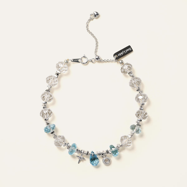 Faceted natural Clear Quartz and Blue Topaz beaded bracelet with 925 sterling silver charms and adjustable chain designed.