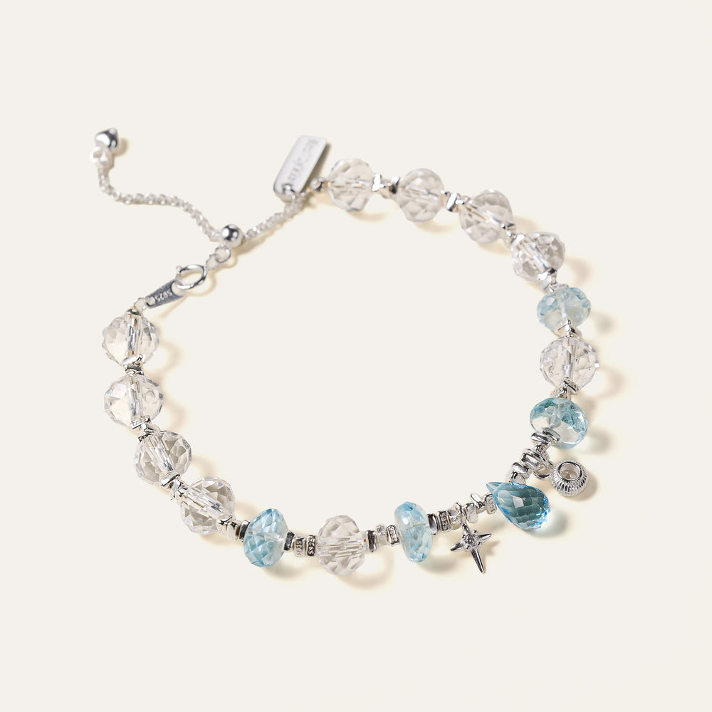Faceted natural Clear Quartz and Blue Topaz beaded bracelet with an adjustable chain and the engraved Soul Lykke signature tag. This is a natural gemstone and healing crystal bracelet by Soul Lykke.