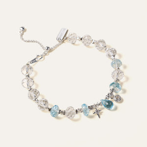Faceted natural Clear Quartz and Blue Topaz beaded bracelet with an adjustable chain and the engraved Soul Lykke signature tag. This is a natural gemstone and healing crystal bracelet by Soul Lykke.