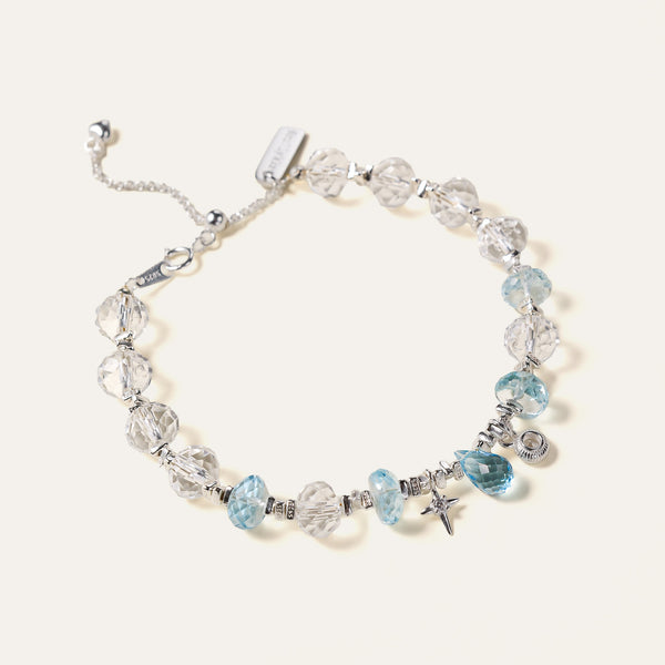 Faceted natural Clear Quartz and Blue Topaz beaded bracelet with an adjustable chain and the engraved Soul Lykke signature tag. This is a natural gemstone and healing crystal bracelet by Soul Lykke.
