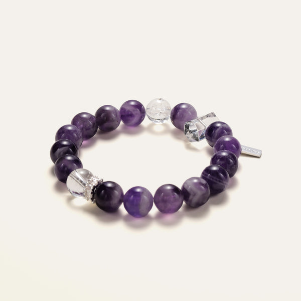 Angled view of the Soul Lykke Lucid Dreamer bracelet, showcasing the striking white banding of natural Dream Chevron Amethyst and icy clear quartz spheres.