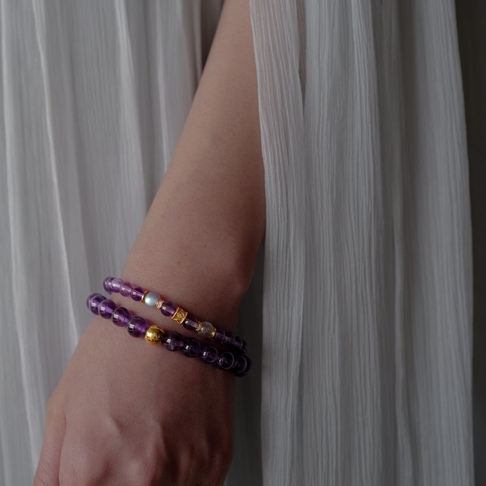 Top-down view of the Soul Lykke Quiet Anchor bracelet on a neutral background, featuring 6mm AA+ Brazil Amethyst, twin AAA Labradorite stones, 24k gold-plated CZ accents, and a signature 14K gold PVD surgical steel tag. This is a natural gemstone and healing crystal bracelet by Soul Lykke.