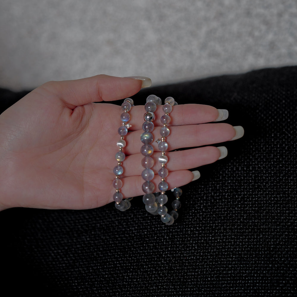 The Core Essential pure labradorite bracelet by Soul Lykke. Crafted from 8mm AAA ice-transparent base stones from Madagascar, this premium crystal jewelry exhibits vivid full-surface flash dominated by electric neon blue and aurora green. This is a natural gemstone bracelet by Soul Lykke.