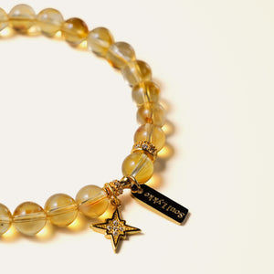 Close-up of premium natural honey-gold Citrine beads, highlighting the delicate 24k gold-plated 925 sterling silver North Star charm and the luminous, unheated crystalline clarity of the gemstones.