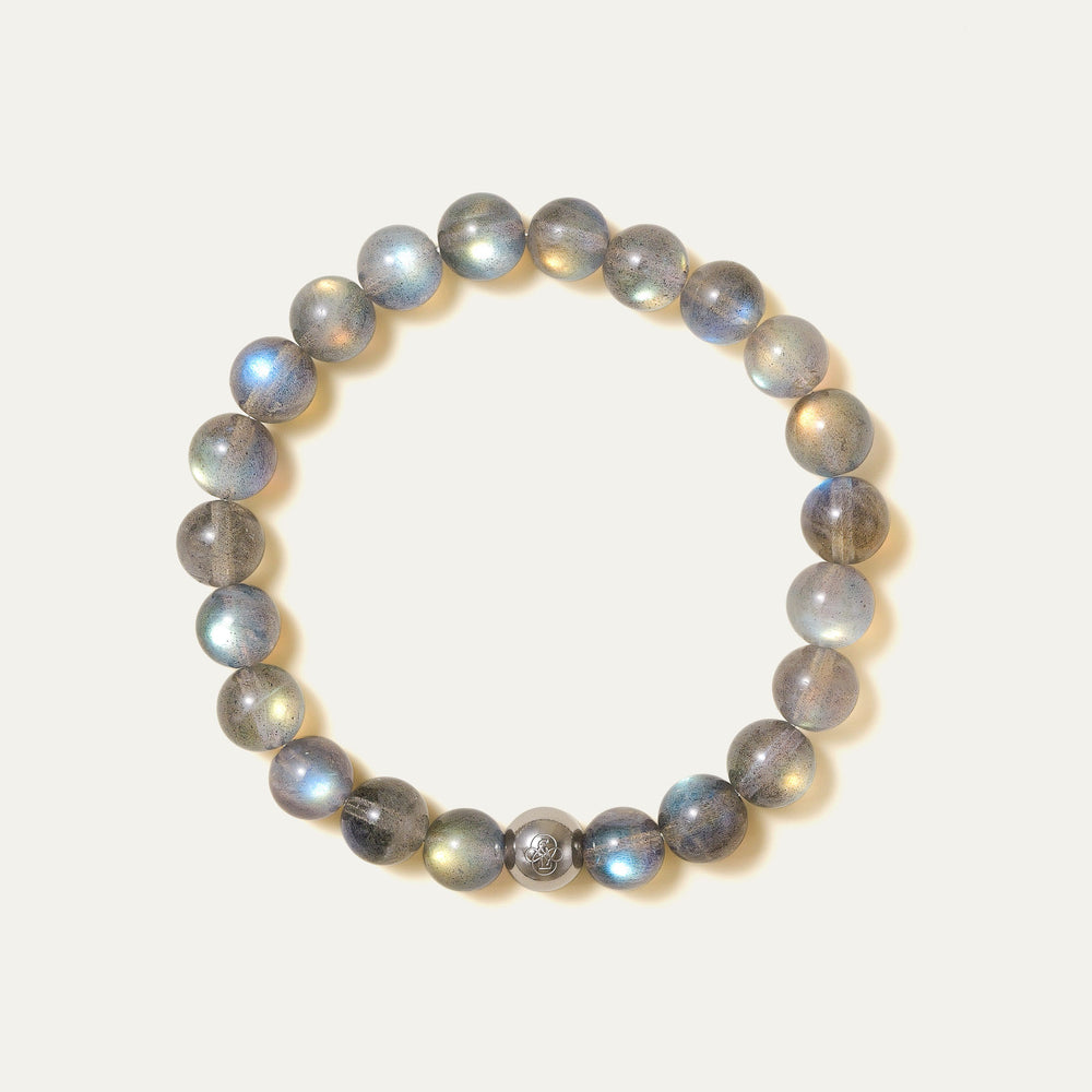 The Core Essential pure labradorite bracelet by Soul Lykke. Crafted from 8mm AAA ice-transparent base stones from Madagascar, this premium crystal jewelry exhibits vivid full-surface flash dominated by electric neon blue and aurora green. This is a natural gemstone bracelet by Soul Lykke.