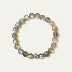 The Core Essential pure labradorite bracelet by Soul Lykke. Crafted from 8mm AAA ice-transparent base stones from Madagascar, this premium crystal jewelry exhibits vivid full-surface flash dominated by electric neon blue and aurora green. This is a natural gemstone bracelet by Soul Lykke.