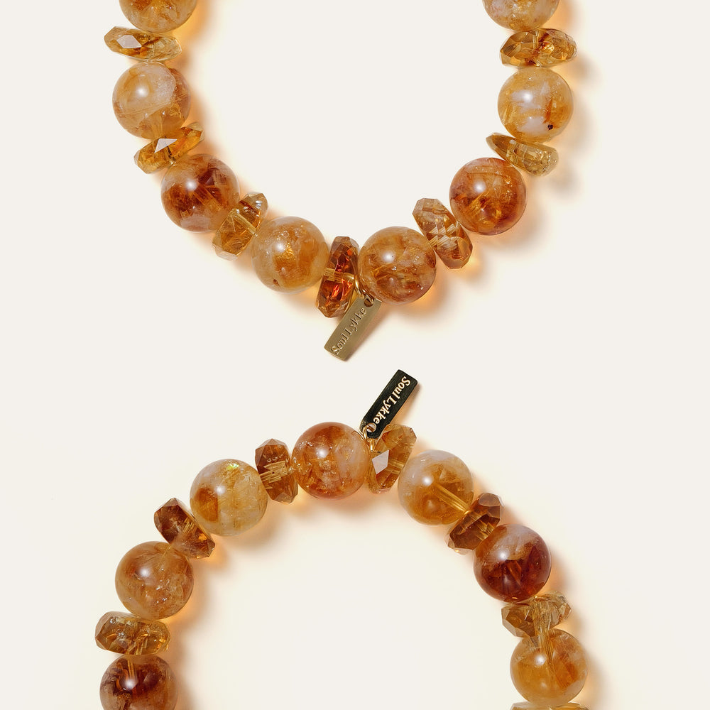 Bold 12mm natural Golden Phantom Citrine beaded bracelet featuring distinct pyramid inclusions and the engraved Soul Lykke signature tag. This is a natural gemstone and healing crystal bracelet by Soul Lykke.