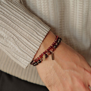 Model wearing a layered stack featuring the Soul Lykke 6mm Black Gold Super Seven bracelet, showcasing understated luxury and quiet authority.