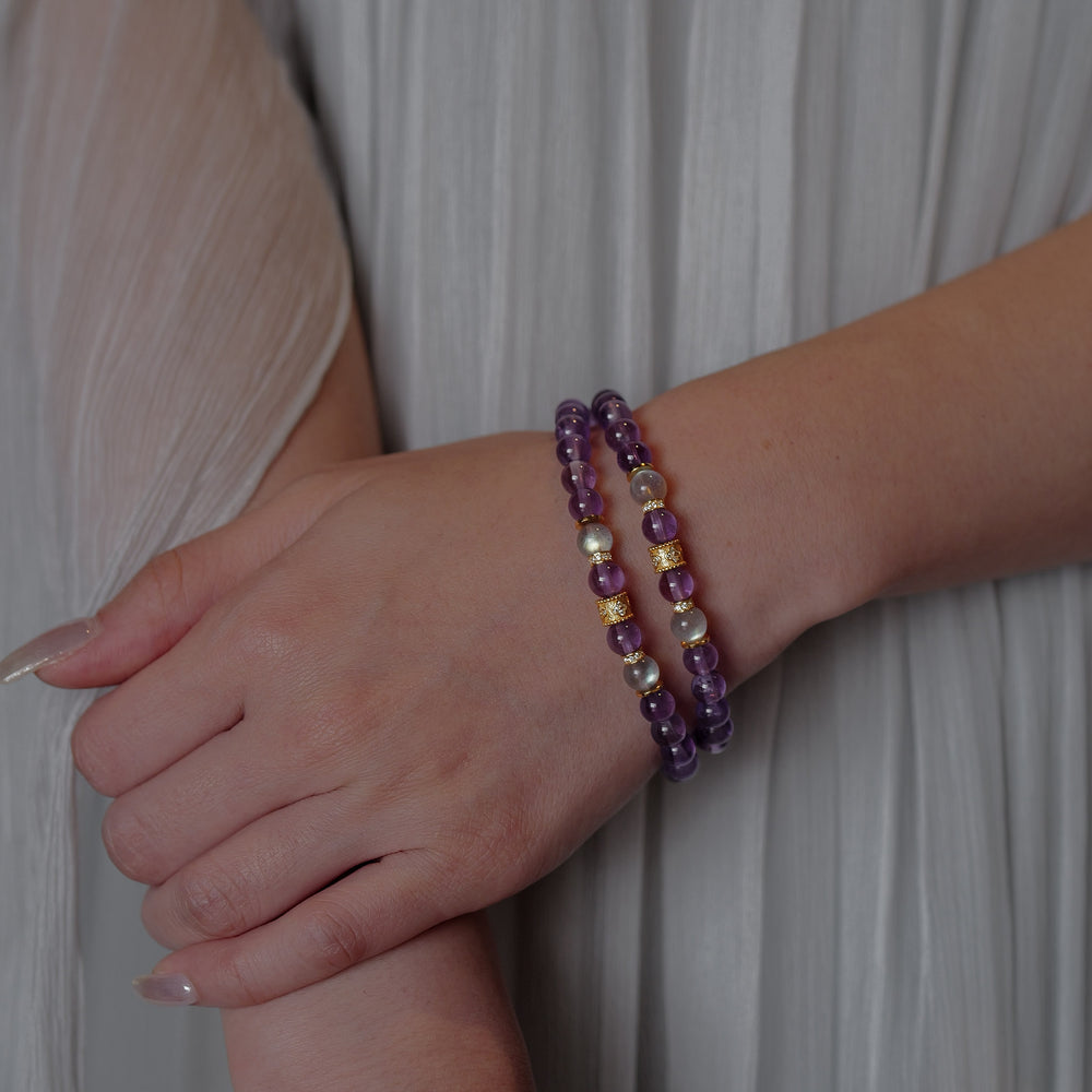 Top-down view of the Soul Lykke Quiet Anchor bracelet on a neutral background, featuring 6mm AA+ Brazil Amethyst, twin AAA Labradorite stones, 24k gold-plated CZ accents, and a signature 14K gold PVD surgical steel tag. This is a natural gemstone and healing crystal bracelet by Soul Lykke.