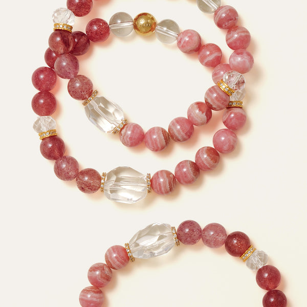 Macro view of beautifully layered natural Lace Rhodochrosite and Star Strawberry Quartz bracelets, featuring faceted Clear Quartz centerpieces and the Soul Lykke signature bead.