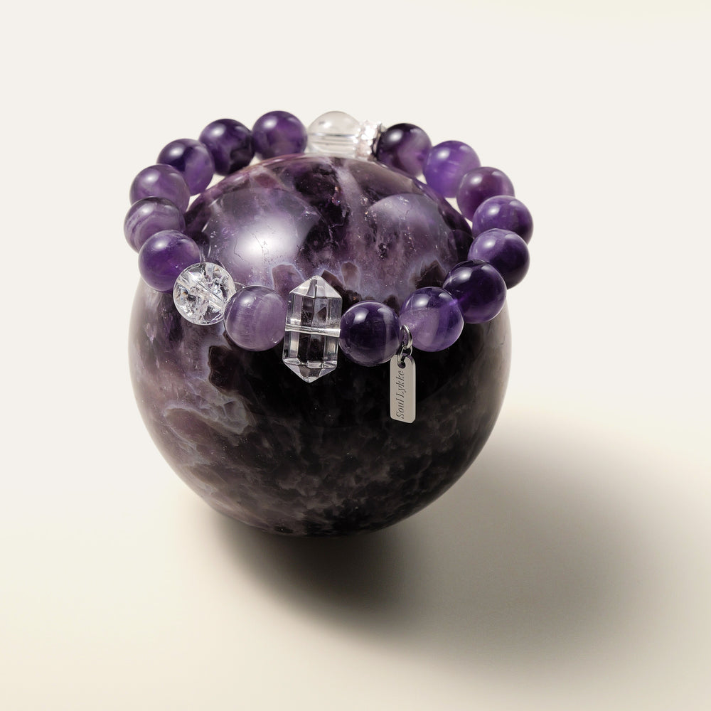 Lucid Dreamer bracelet featuring 10.5mm Dream Chevron Amethyst, a double-terminated clear quartz point, and the Soul Lykke signature white gold PVD tag. This is a natural gemstone and healing crystal bracelet by Soul Lykke.