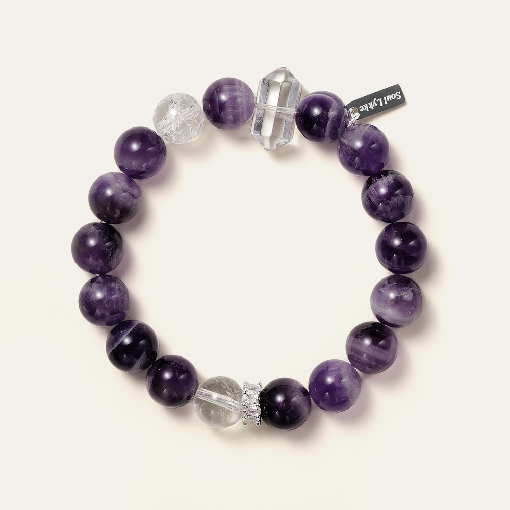 Lucid Dreamer bracelet featuring 10.5mm Dream Chevron Amethyst, a double-terminated clear quartz point, and the Soul Lykke signature white gold PVD tag. This is a natural gemstone and healing crystal bracelet by Soul Lykke.
