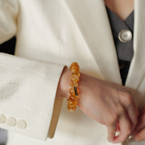 Close-up of a 12mm AAA Golden Phantom Citrine bracelet, highlighting deep amber whiskey tones, faceted cuts, and multi-layered pyramids.