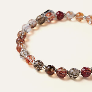 Close-up of premium Black Gold Super Seven beads, highlighting cloudless glass-clear quartz, vivid golden rutiles, and 925 silver spacers.