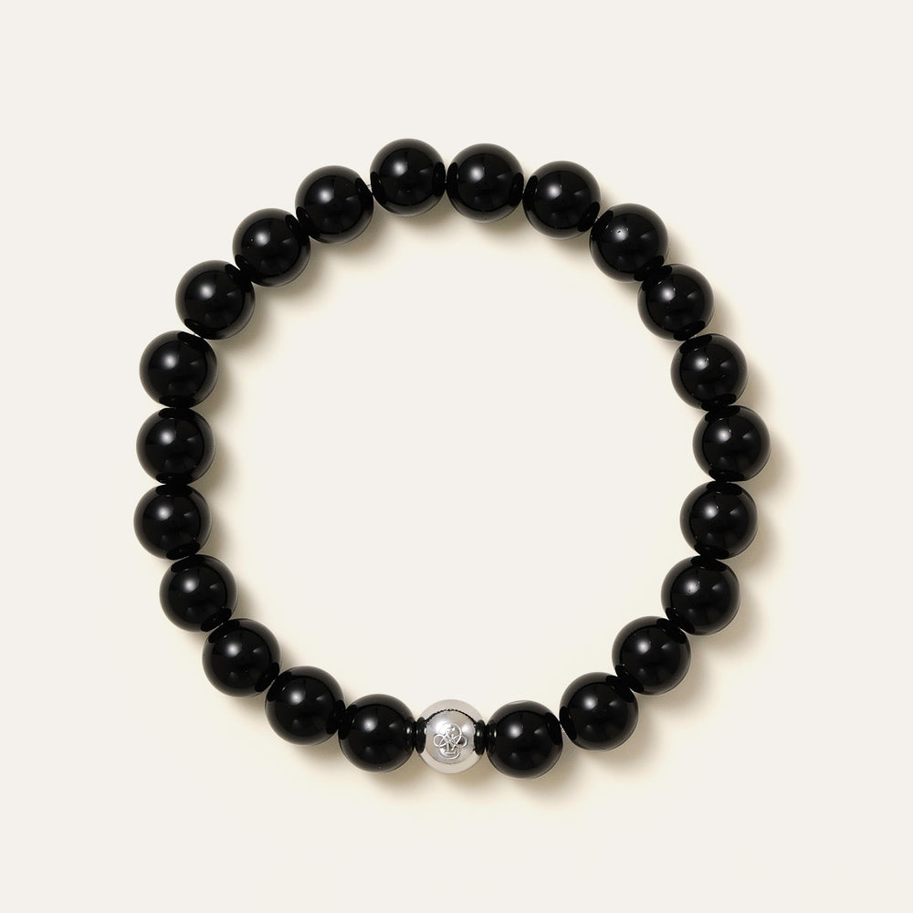The Core Essential bracelet by Soul Lykke, featuring 8mm natural AAA black obsidian ethically sourced from Mexico, paired with a single hypoallergenic white gold PVD surgical steel signature bead. This is a natural gemstone and healing crystal bracelet by Soul Lykke.
