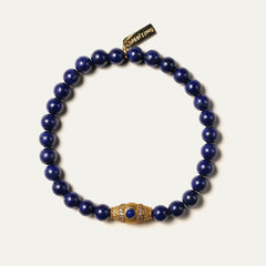 The Royal Vesper bracelet by Soul Lykke, featuring 6mm AAA-grade natural Afghan Lapis Lazuli. This luxury crystal jewelry showcases deep royal blue stones with golden pyrite flakes and an intricate pavé CZ gold barrel bead. This is a natural gemstone bracelet by Soul Lykke.