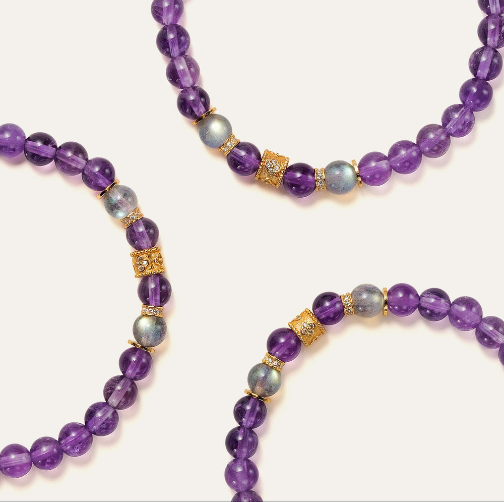 Top-down view of the Soul Lykke Quiet Anchor bracelet on a neutral background, featuring 6mm AA+ Brazil Amethyst, twin AAA Labradorite stones, 24k gold-plated CZ accents, and a signature 14K gold PVD surgical steel tag. This is a natural gemstone and healing crystal bracelet by Soul Lykke.