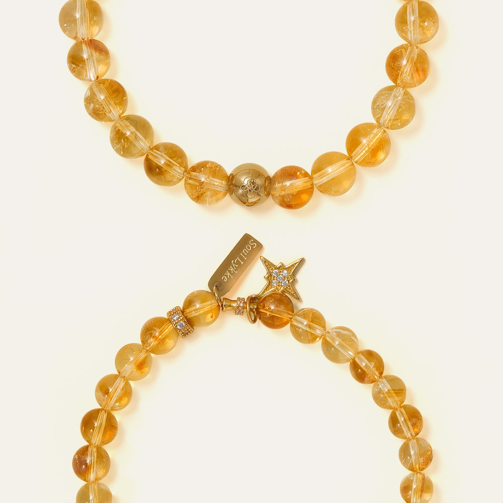 Top view of a perfect premium grade natural Honey Citrine beaded bracelet with 8mm gems and a solitary 14K gold PVD signature bead, representing abundance and success, Core Essential collection. This is a natural gemstone and healing crystal bracelet by Soul Lykke.