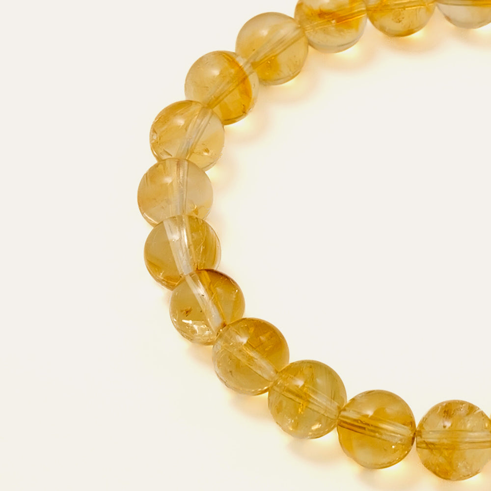 Top view of a perfect premium grade natural Honey Citrine beaded bracelet with 8mm gems and a solitary 14K gold PVD signature bead, representing abundance and success, Core Essential collection. This is a natural gemstone and healing crystal bracelet by Soul Lykke.