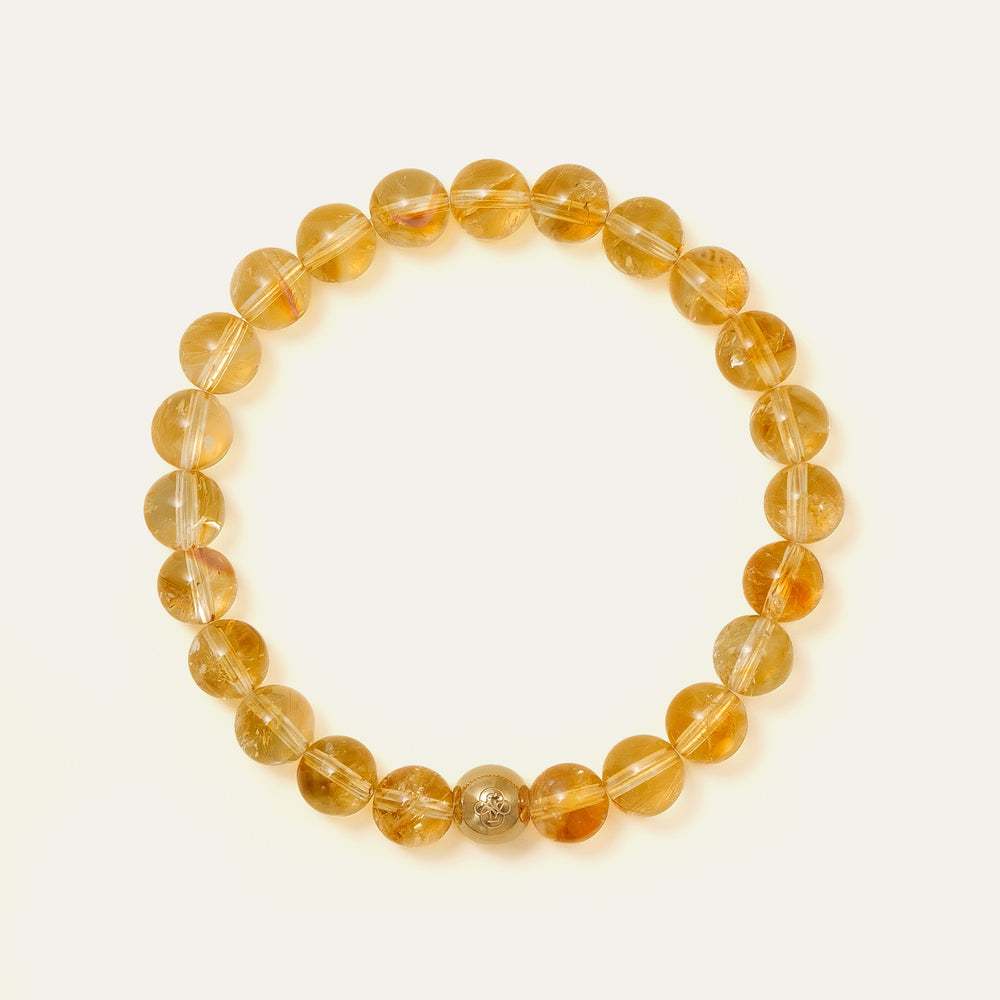 Top view of a perfect premium grade natural Honey Citrine beaded bracelet with 8mm gems and a solitary 14K gold PVD signature bead, representing abundance and success, Core Essential collection. This is a natural gemstone and healing crystal bracelet by Soul Lykke.