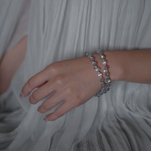 Close-up of a handcrafted natural Labradorite bracelet on a woman's wrist, highlighting the striking blue flashes and delicate 925 sterling silver star accents.