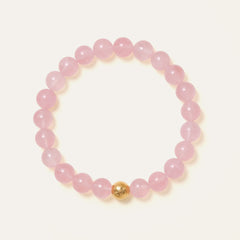 Core Essential bracelet featuring 8mm AAA natural Madagascar Hibiscus Rose Quartz and the Soul Lykke 14K gold PVD signature bead. This is a natural gemstone and healing crystal bracelet by Soul Lykke.