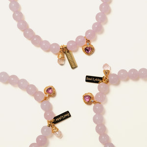 Multiple Soul Lykke Soft Bloom bracelets showcasing the delicate 6mm semi-translucent Rose Quartz beads and sparkling pink tourmaline heart charms.