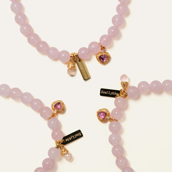 Multiple Soul Lykke Soft Bloom bracelets showcasing the delicate 6mm semi-translucent Rose Quartz beads and sparkling pink tourmaline heart charms.