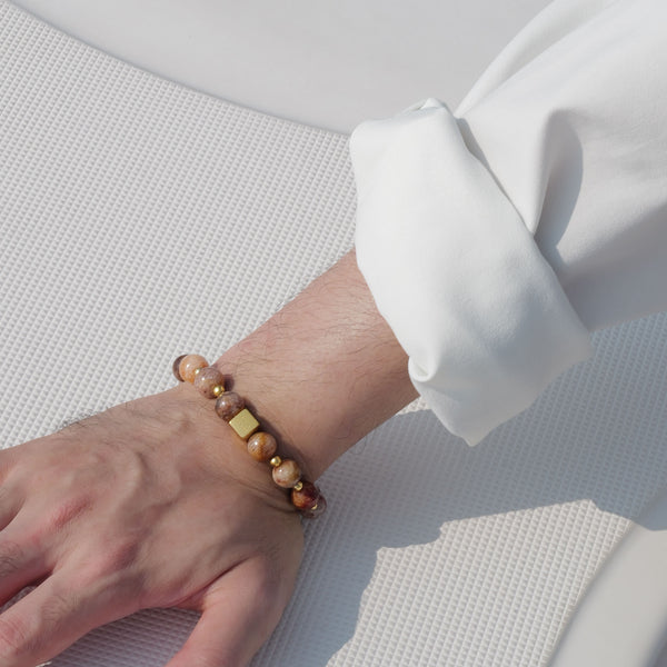 Close-up of the Soul Lykke 10mm AAA Layered Phantom Quartz bracelet, highlighting earthy mineral strata and a 14K gold square signature bead.