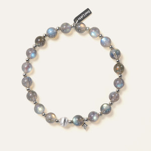 Top-down view of the Soul Lykke Inner Universe bracelet, featuring 6.5-7mm natural AAA-grade Madagascar Labradorite with vivid spectral flashes, accented by 925 sterling silver hardware and a white gold PVD surgical steel tag. This is a natural gemstone and healing crystal bracelet by Soul Lykke.