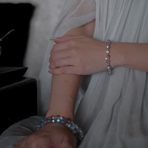 Model gracefully wearing the Soul Lykke Inner Universe premium Labradorite bracelet with a white pleated dress, showcasing effortless elegance and demi-fine craftsmanship.