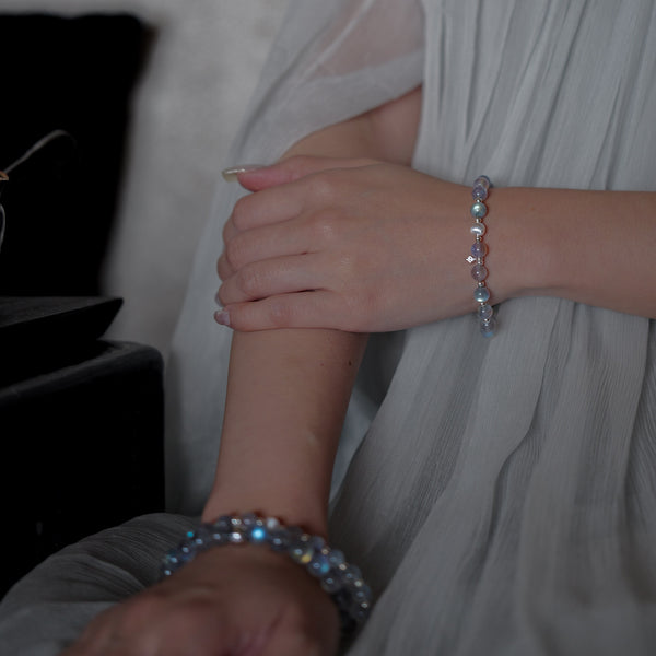 Model gracefully wearing the Soul Lykke Inner Universe premium Labradorite bracelet with a white pleated dress, showcasing effortless elegance and demi-fine craftsmanship.