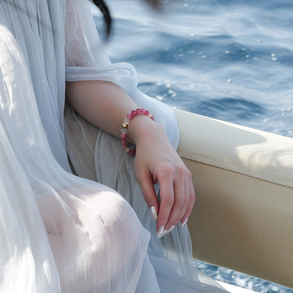 Elegant beaded bracelet combining 8mm natural Lace Rhodochrosite, Star Strawberry Quartz, and a faceted Clear Quartz centerpiece, featuring the Soul Lykke signature gold bead. This is a natural gemstone and healing crystal bracelet by Soul Lykke.