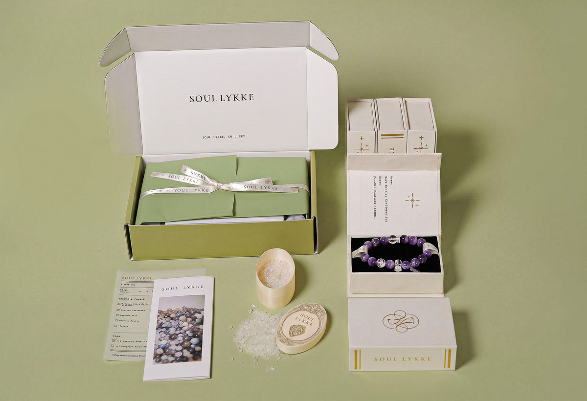 Complimentary luxury unboxing experience by Soul Lykke. Each crystal jewelry piece arrives in a premium sage green gift box, complete with an authenticity card and a natural clear quartz cleansing kit.