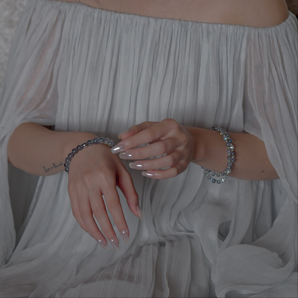 The Core Essential pure labradorite bracelet by Soul Lykke. Crafted from 8mm AAA ice-transparent base stones from Madagascar, this premium crystal jewelry exhibits vivid full-surface flash dominated by electric neon blue and aurora green. This is a natural gemstone bracelet by Soul Lykke.