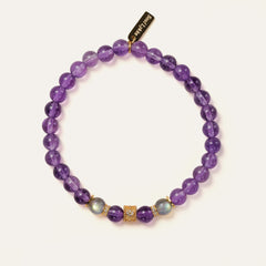 Top-down view of the Soul Lykke Quiet Anchor bracelet on a neutral background, featuring 6mm AA+ Brazil Amethyst, twin AAA Labradorite stones, 24k gold-plated CZ accents, and a signature 14K gold PVD surgical steel tag. This is a natural gemstone and healing crystal bracelet by Soul Lykke.