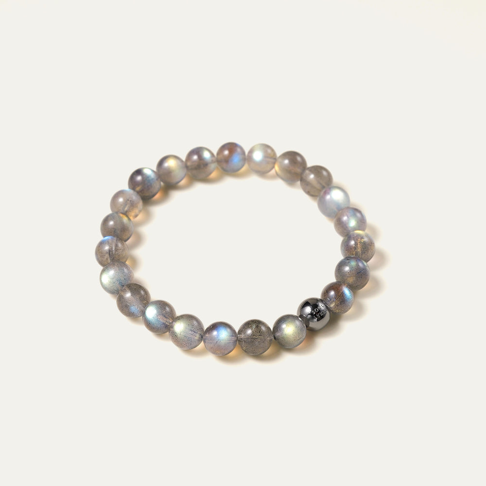 The Core Essential pure labradorite bracelet by Soul Lykke. Crafted from 8mm AAA ice-transparent base stones from Madagascar, this premium crystal jewelry exhibits vivid full-surface flash dominated by electric neon blue and aurora green. This is a natural gemstone bracelet by Soul Lykke.